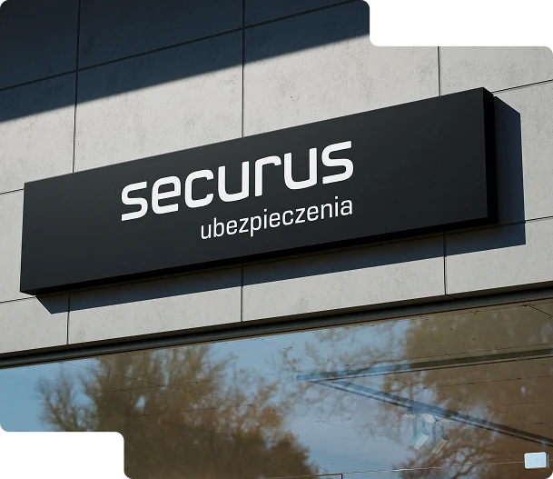 Na zdjęciu widoczny jest nowoczesny czarny szyld reklamowy z białym logotypem Media Essence. Szyld jest zamontowany na elewacji budynku